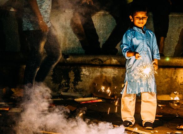 A boy watches a sparkler burn during Diwali A boy watches a sparkler burn during Diwali