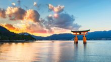 Photograph the iconic scarlet torii, a giant camphor-wood gate at the entrance to the Itsukushima Shrine, a World Heritage Site and a sacred site of pilgrimage. At high tide it appears to float in the surrounding waters.