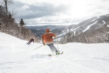 Skier's enjoy fresh powder on a Maine ski slope.