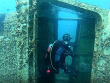 A Hervey Bay Dive Centre staff member has an early look at the ex-HMAS Tobruk wreck.