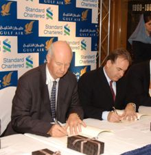 Mr Hogan, right and Mr Fish sign the papers
