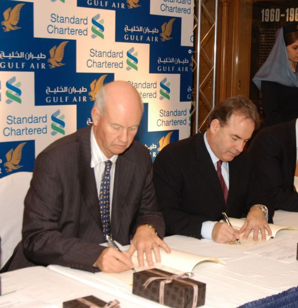 Mr Hogan, right and Mr Fish sign the papers