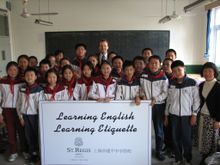 Seen in picture, Mr. Charles Abbott, General Manager of St. Regis Hotel, Shanghai and the students of Jian Ping Junior High Scho