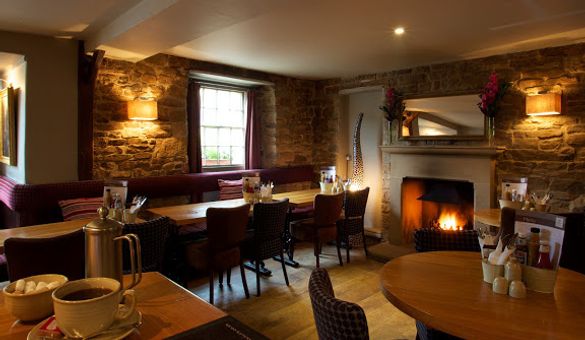 Dining Area with Fireplace at The Devonshire Arms at Pilsley