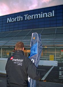 Meteor meet and greet driver helps customer by unloading ski equipment at airport terminal