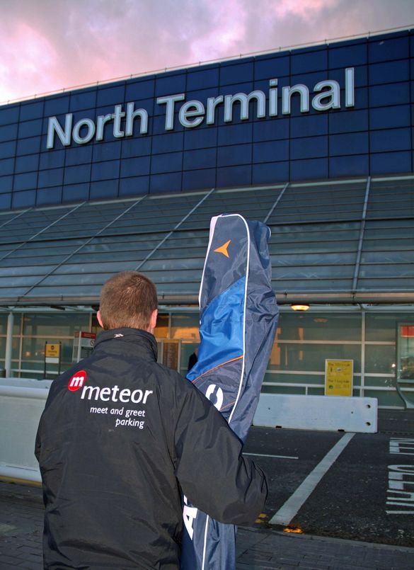 Meteor meet and greet driver helps customer by unloading ski equipment at airport terminal