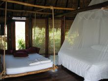 queen size bed inside one of Azulik's cabanas 2