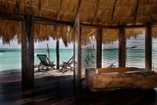 view of the ocean taken from inside cabana at Azulik
