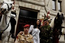 Major Phil Packer, Royal Military Police, left, and Lt. Col. David Richmond, Royal Scots Guards, right, pose with The Household 