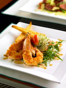 Main St. Deli - Ginger lime drenched king prawns on bed of arugula, shredded carrot, celery and radish with foccacia croutons an