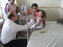 Bernd Schneider attends to one of the patient after the operation 