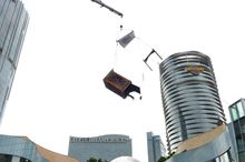 The crate with Franz and Fiona inside slowly suspends in the sky