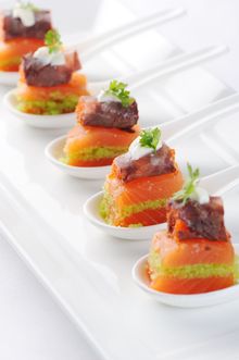 Layered Balik style salmon, confit beef with black tobiko caviar and wasabi caviar