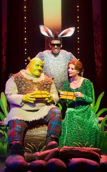 Dean Chisnall (Shrek), Richard Blackwood (Donkey) and Carley Stenson (Princess Fiona) in Shrek The Musical (RETOUCHED). Image by