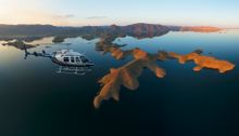 HeliSpirit helicopter flying over Lake Argyle