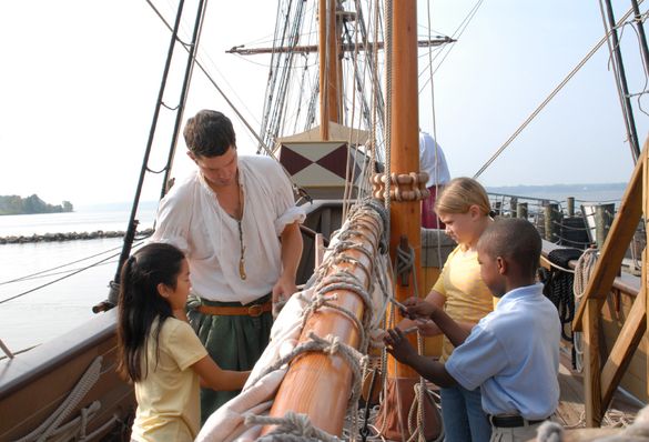 Visitors learn how to untie sails on the Discovery.