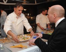 Raymond Blanc serves guests at the Diner des Grands Chefs in London