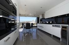 The Well-Equipped High Gloss White Kitchen Comes With Dark Granite Work Tops And Miele Equipment Throughout.  This Includes The 