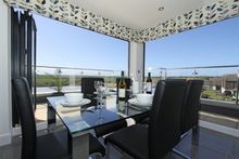 Next To The Kitchen Is The Chic Dining Area With A Table Seating Six.  Direct Access To The Outside Terrace Means You Can Dine I