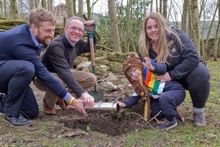 Burying the time capsule in the grounds of Castleton Youth Hostel (l - r) Ian Priddle - Manager of YHA Castleton, James Blake - Chief Executive of YHA (England and Wales) with YHA guests Jackson Holt (3) and Stephanie Hall.