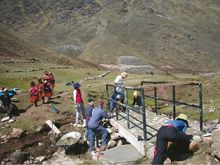 Participants on a World Expeditions trip to Qelqenca in Peru build a bridge