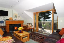 The living room, located on the first floor, opens out on to the generous balcony, flooding the room with natural light and givi