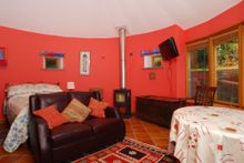 Downstairs are three beautifully finished bedrooms including the cavernous master ‘round room’ with stunning views over the tida