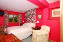 The third bedroom, is furnished with a double bed, two bedside cabinets with lamps, an integrated wardrobe, chest of drawers, mi