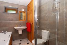 The en-suite features a bath, separate shower cubicle, wc, wash basin, heated towel rail and mirror.
