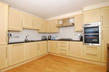 The Large And Well Equipped Kitchen At 16 Combehaven, Which Comes With A Breakfast Bar That Looks Out Over The Dramatic Estuary