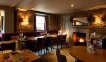 Dining Area with Fireplace at The Devonshire Arms at Pilsley