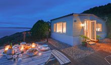  Outside lies the impressive suspended L-shaped decking that takes you out over sloped cliff edge.  Here you can sit and watch b