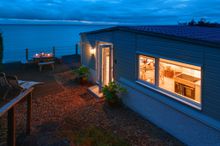  Outside lies the impressive suspended L-shaped decking that takes you out over sloped cliff edge.  Here you can sit and watch b