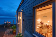 Outside lies the impressive suspended L-shaped decking that takes you out over sloped cliff edge.  Here you can sit and watch bo