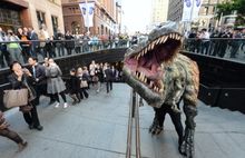 Tyrannosaur takes a morning stroll with commuters in Sydney en route to a new exhibition at the Australia Museum