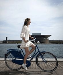 Girl On Bike In Front Of The Opera House In Copenhagen