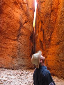 WAs best jobs winner Taste Master Rich Keam looking up at Echidna Chasm, Bungle Bungle Range, Purnululu National Park in WAs Nor
