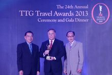 Mr Desmond Hatton (centre), General Manager of Dusit Thani Maldives, receives the award for Best New Beach Resort Hotel at the 2