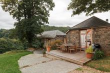 Coombe Farm, a luxurious converted barn, which comes with its own pool, cinema and wraparound garden, all set within 28 acres of