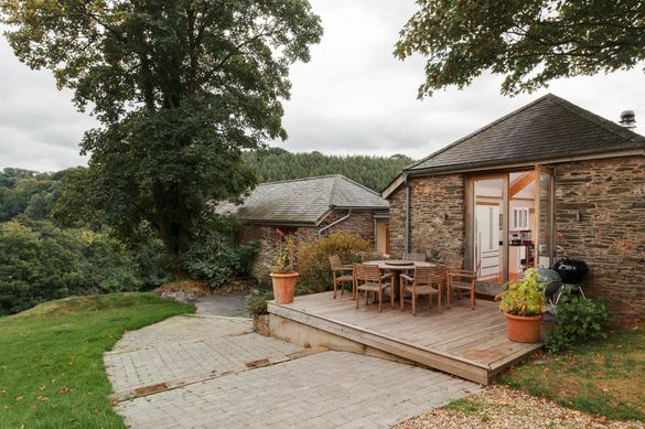 Coombe Farm, a luxurious converted barn, which comes with its own pool, cinema and wraparound garden, all set within 28 acres of