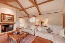 Coombe Farm has high vaulted ceilings, teak flooring, Persian carpets, attractive oak staircase, fine furnishings and fixtures, 