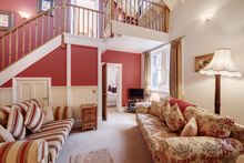 Sleeping four, this elegant two bedroom cottage, has many original features including high ceilings, wooden beams, and pretty or