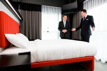 Nathan Copsey - GM of Tune Hotel Melbourne (right) briefing Dr Denis Napthine - Premier of Victoria during a room tour of the br