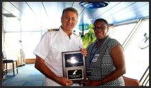 Acting Chief Executive Officer, Carolyn James, Commemorates The Inaugural Visit Of The Carnival Conquest With A Plaque Exchange 
