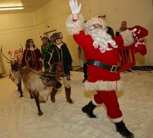 Santa and the real reindeer walking onto the snow at Snozone