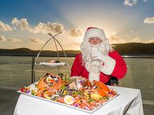 Santa enjoys a Queensland feast, swapping milk and cookies for milk and crab claws