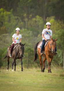Chinese guests riding a horse in Australian bush, Spicers Hidden Vale. Queensland Australia. Tourism and Events Queensland