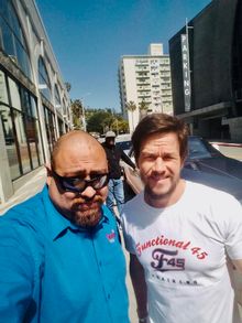 Mark Wahlberg stops to let a Starline Tours guide snap a photo.