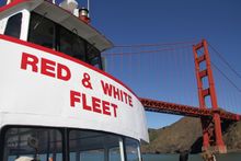 Red and White Fleet boat cruising near the Golden Gate Bridge