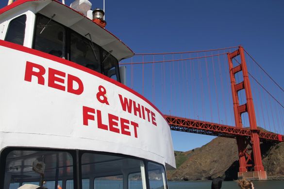 Red and White Fleet boat cruising near the Golden Gate Bridge